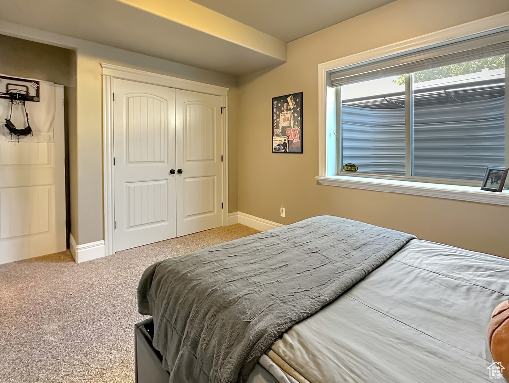 Bedroom featuring carpet and a closet