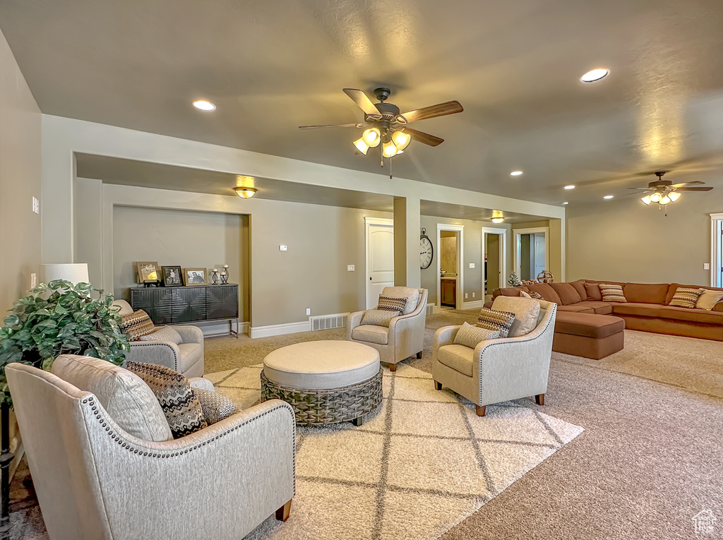 Living room featuring carpet floors and ceiling fan
