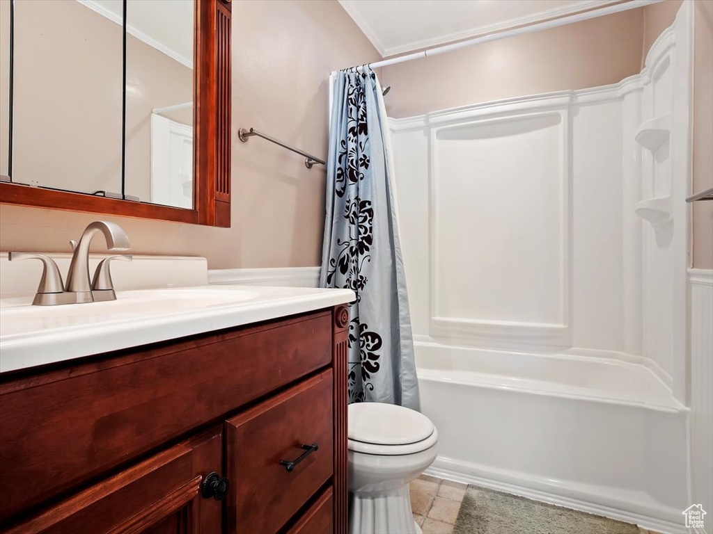 Full bathroom featuring crown molding, vanity, shower / tub combo with curtain, tile flooring, and toilet