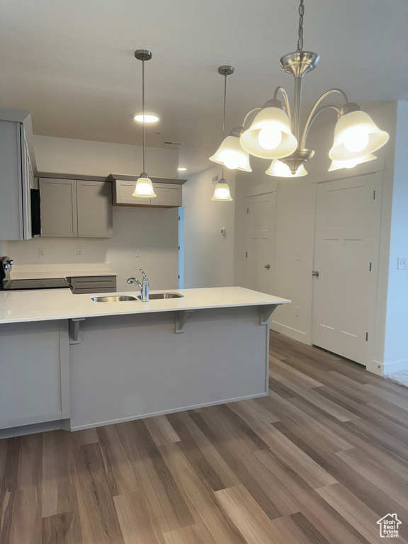 Kitchen featuring decorative light fixtures, dark hardwood / wood-style flooring, and stove