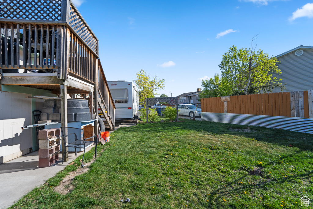 View of yard with a patio and a wooden deck