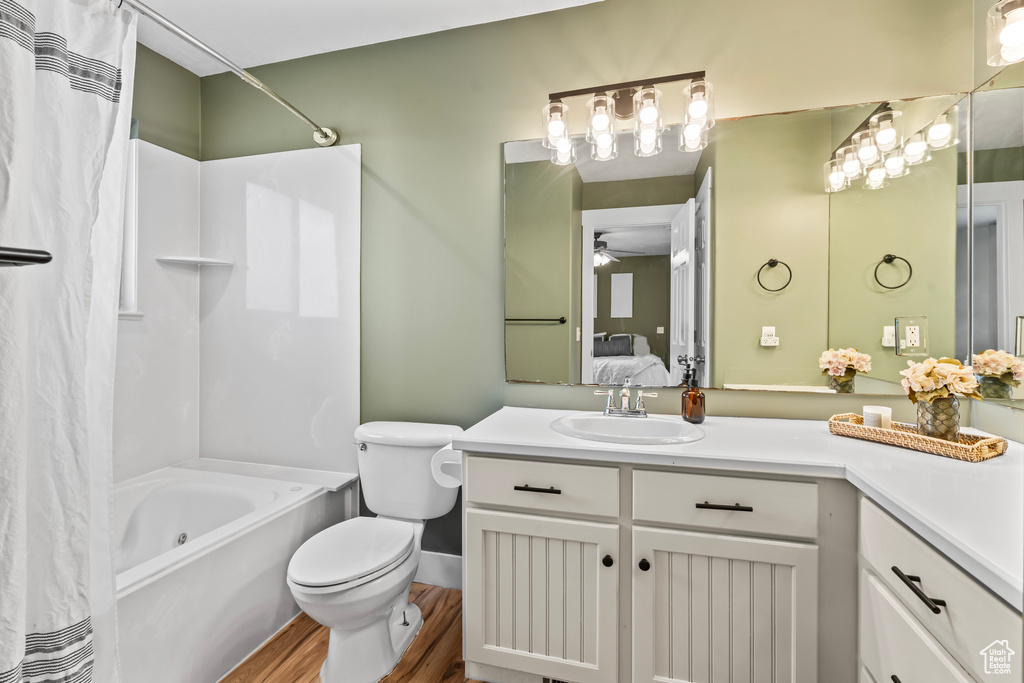 Bathroom with ceiling fan, vanity, hardwood / wood-style flooring, and toilet