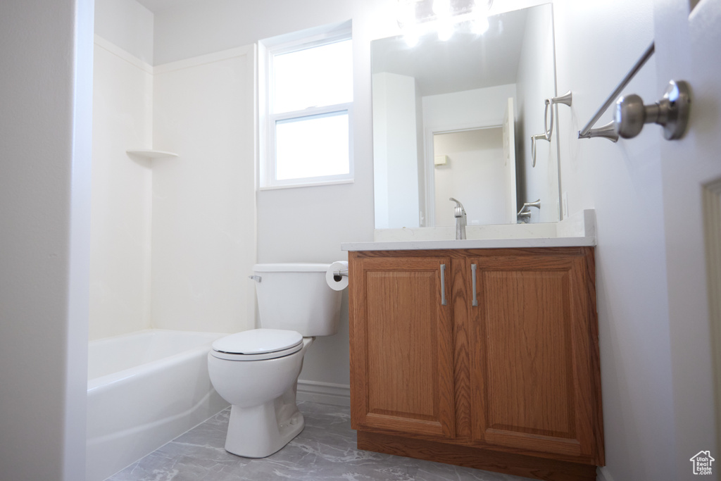 Full bathroom featuring vanity, tile floors, toilet, and shower / bathtub combination