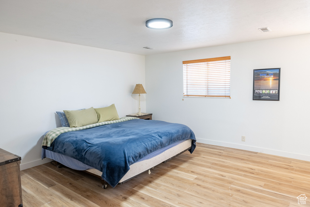 Bedroom with hardwood / wood-style floors