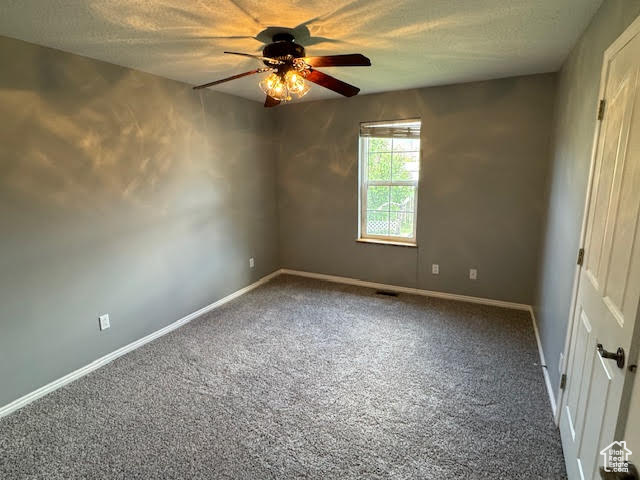 Spare room featuring ceiling fan and carpet flooring