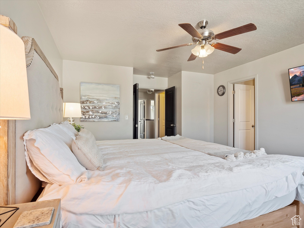Bedroom featuring a textured ceiling and ceiling fan