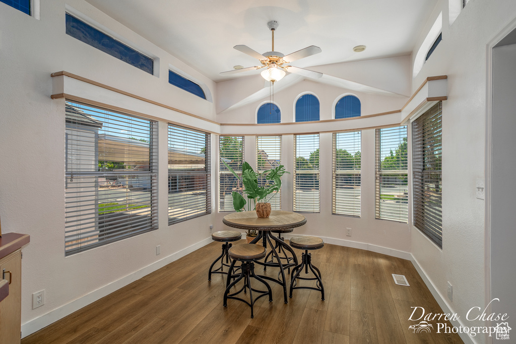 Dining area with ceiling fan, hardwood / wood-style floors, and vaulted ceiling