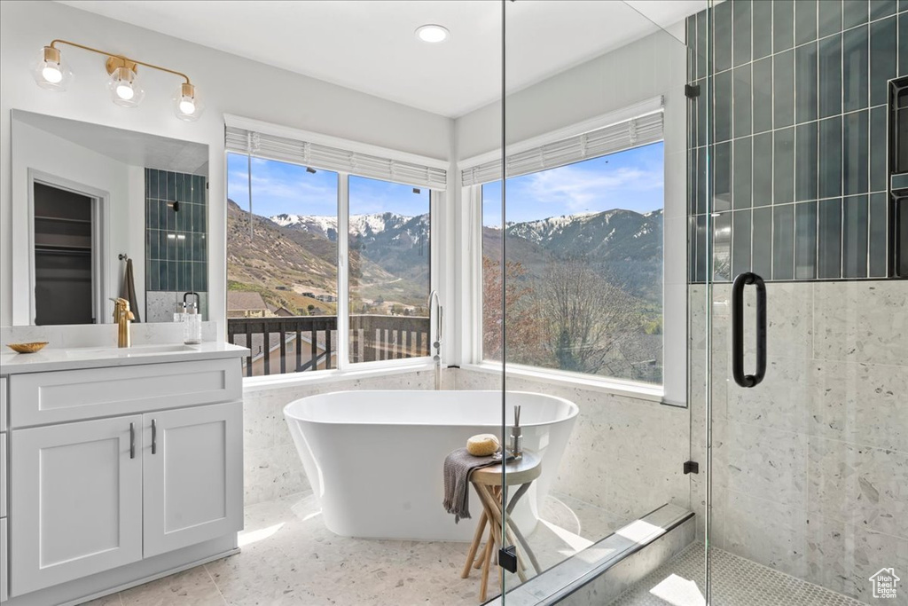 Bathroom with independent shower and bath, vanity, a mountain view, and tile floors
