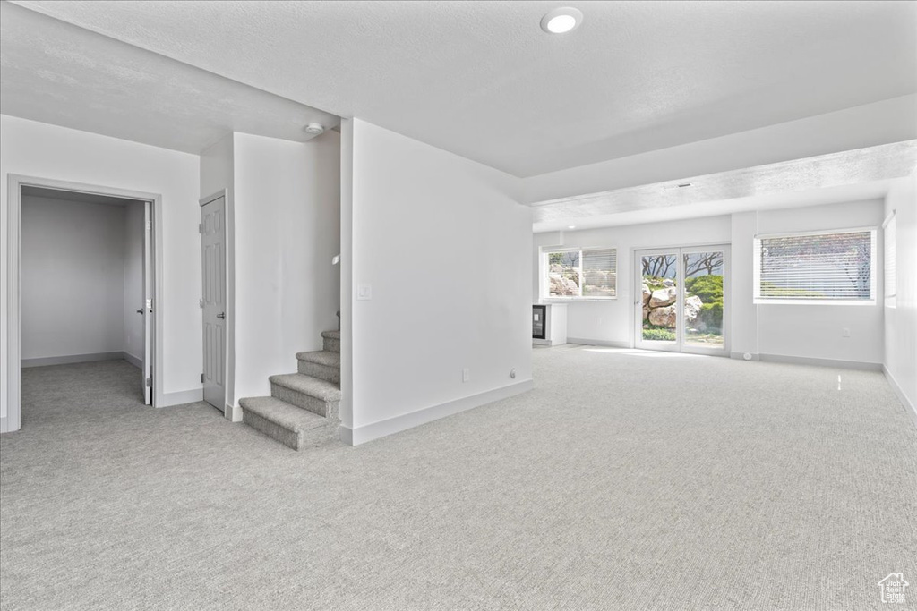 Unfurnished living room featuring carpet floors