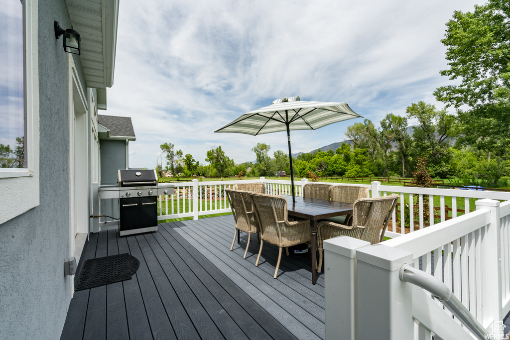 Wooden terrace featuring grilling area