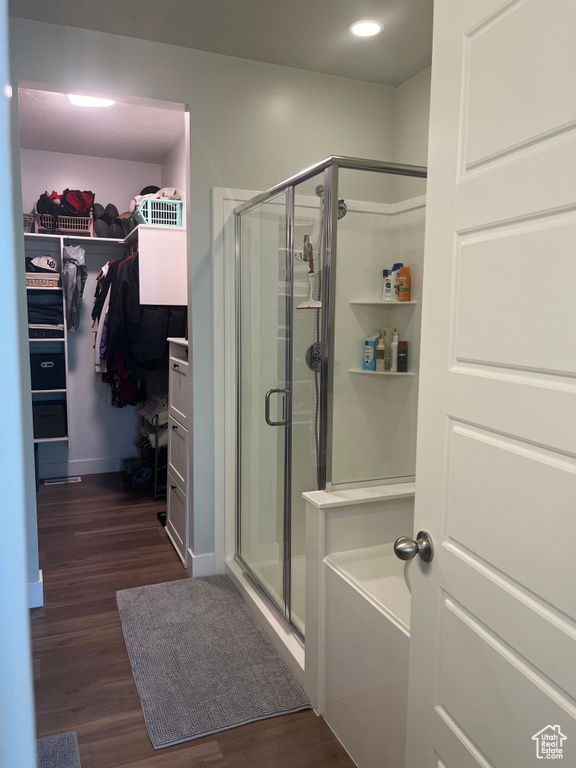 Bathroom featuring shower with separate bathtub and hardwood / wood-style flooring
