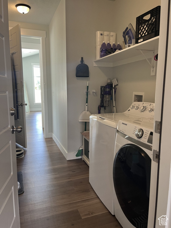 Laundry area with washing machine and dryer, hookup for a washing machine, and dark hardwood / wood-style floors