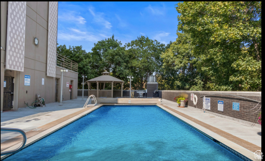 View of swimming pool with a patio area and a gazebo