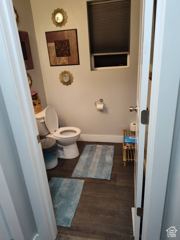 Bathroom with wood-type flooring and toilet