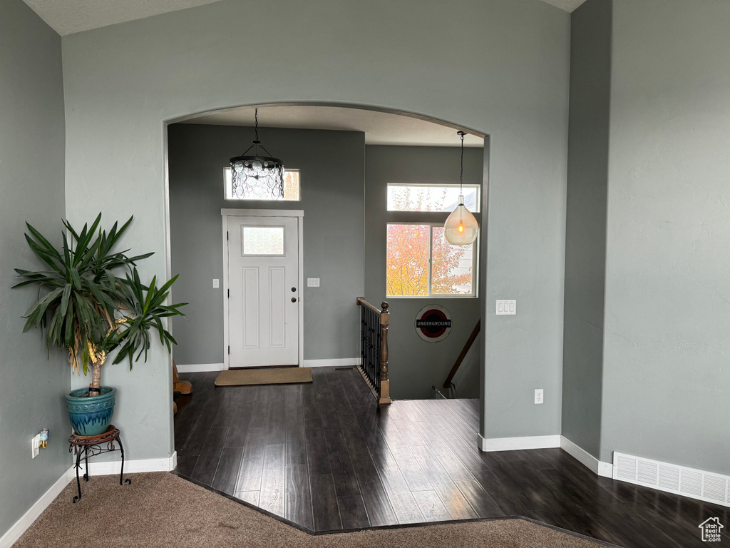 Foyer with dark hardwood / wood-style flooring