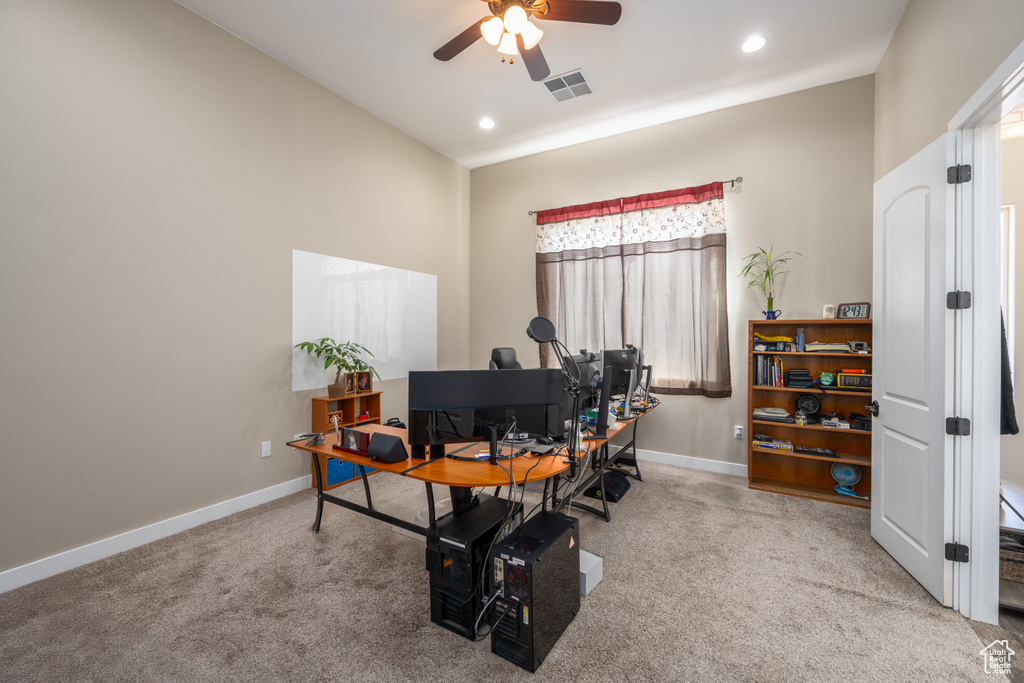 Office area with ceiling fan and carpet