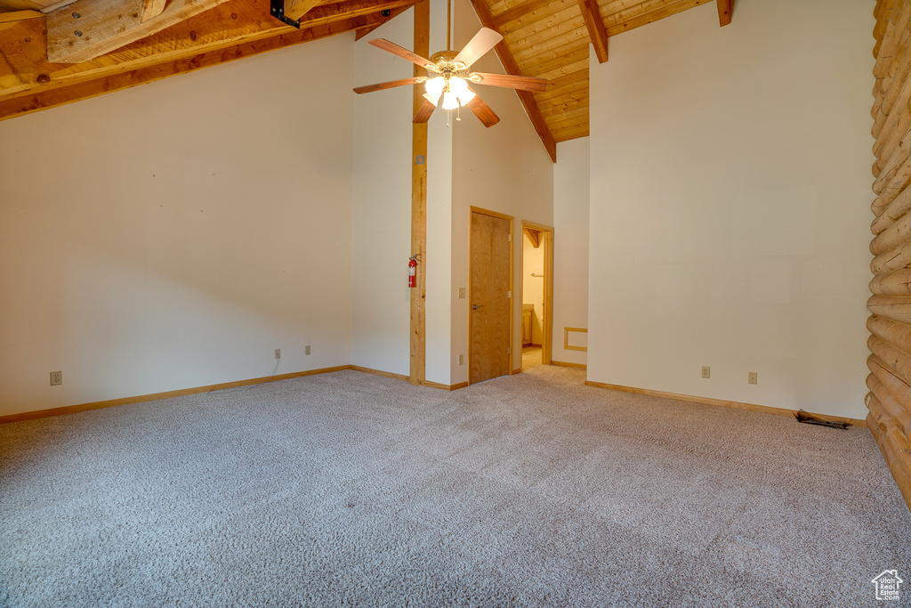 Empty room featuring wood ceiling, ceiling fan, and carpet flooring