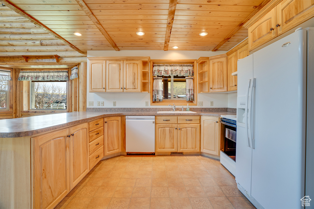 Kitchen with log walls, white appliances, light tile flooring, and wooden ceiling