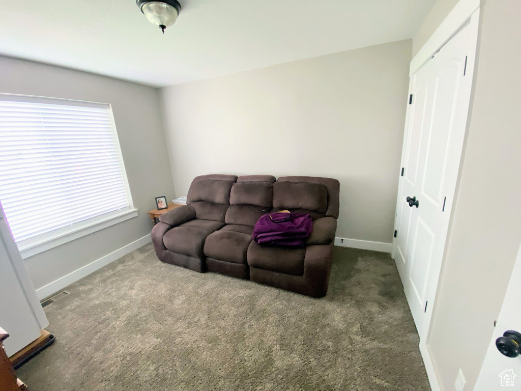 Sitting room with dark colored carpet