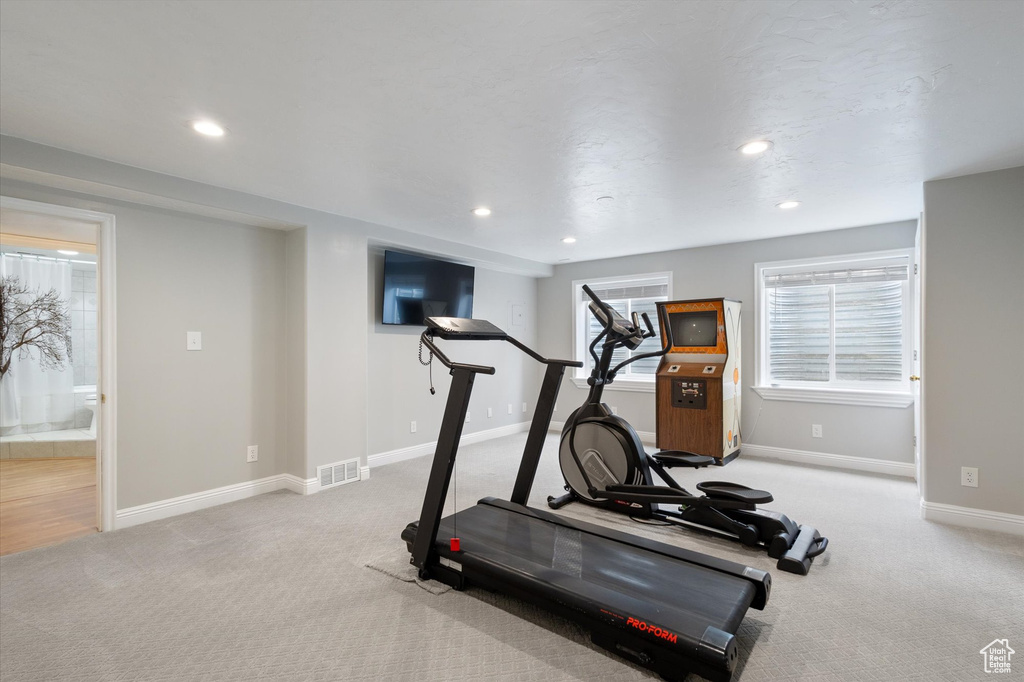 Workout room with light colored carpet