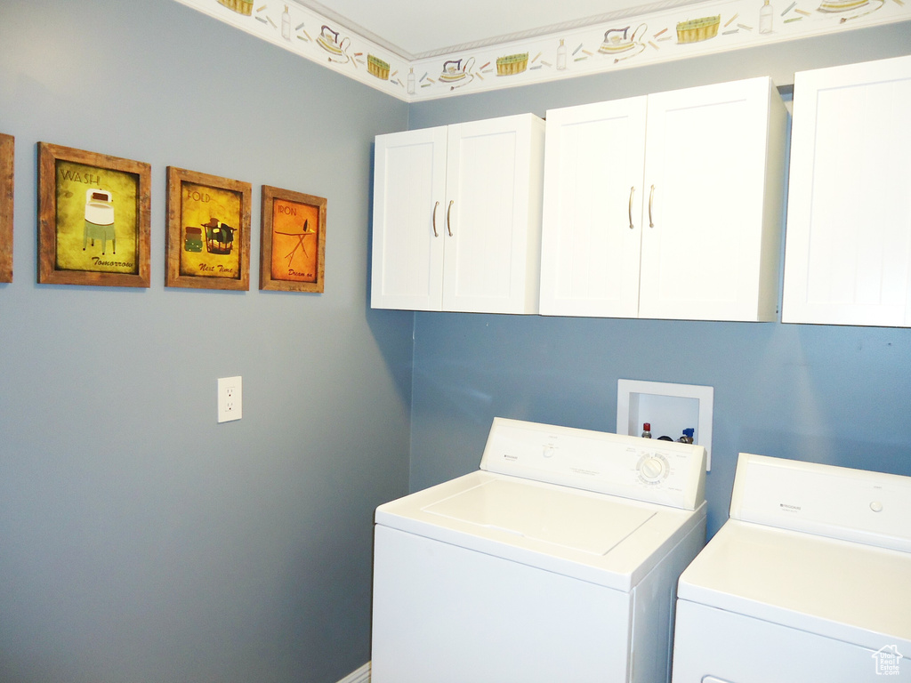 Laundry room with cabinets, hookup for a washing machine, and separate washer and dryer