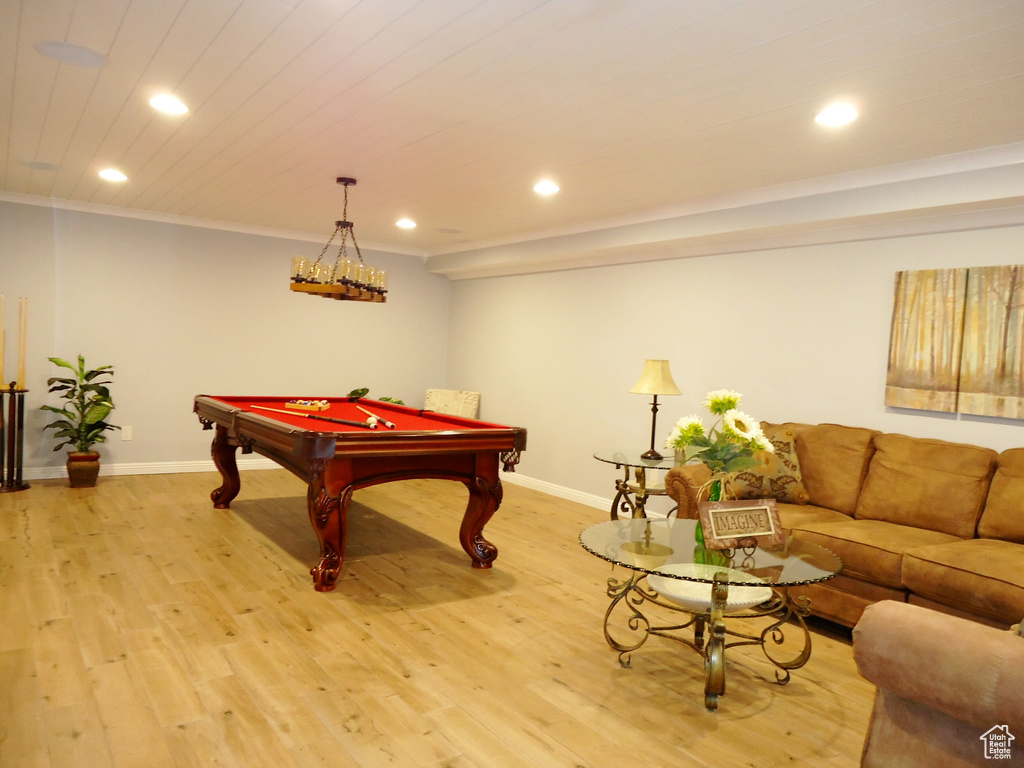 Rec room featuring wood-type flooring, pool table, and ornamental molding
