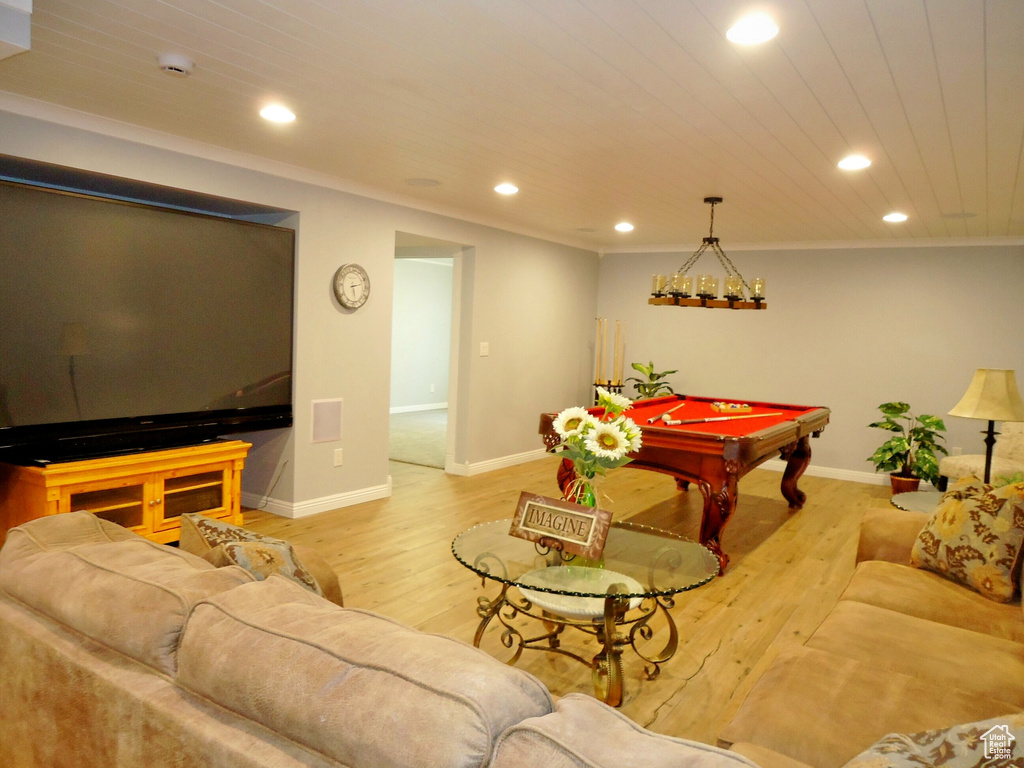 Game room with billiards, light hardwood / wood-style floors, and ornamental molding