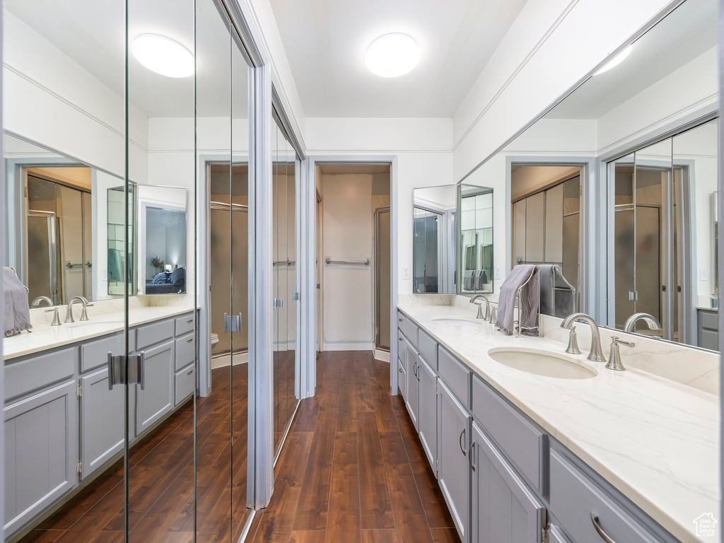 Bathroom with double sink, wood-type flooring, and oversized vanity