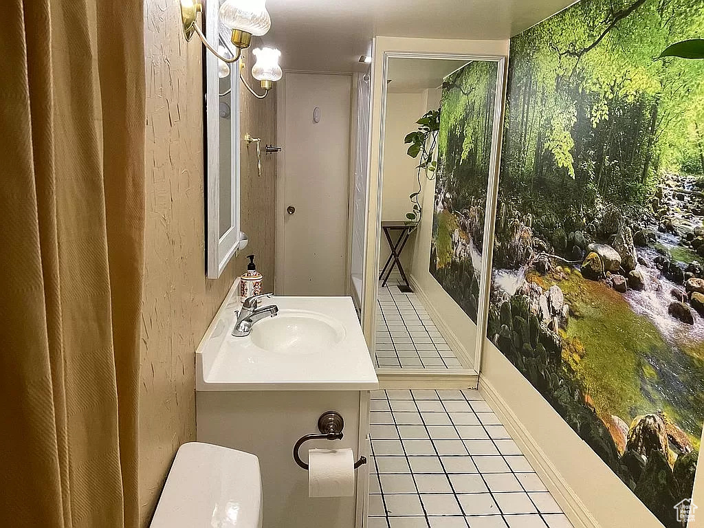 Bathroom with tile flooring and vanity