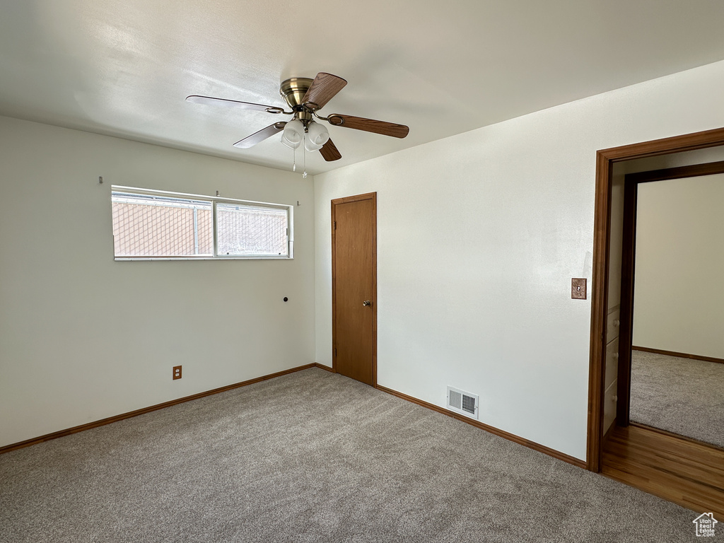 Unfurnished bedroom with a closet, ceiling fan, and carpet