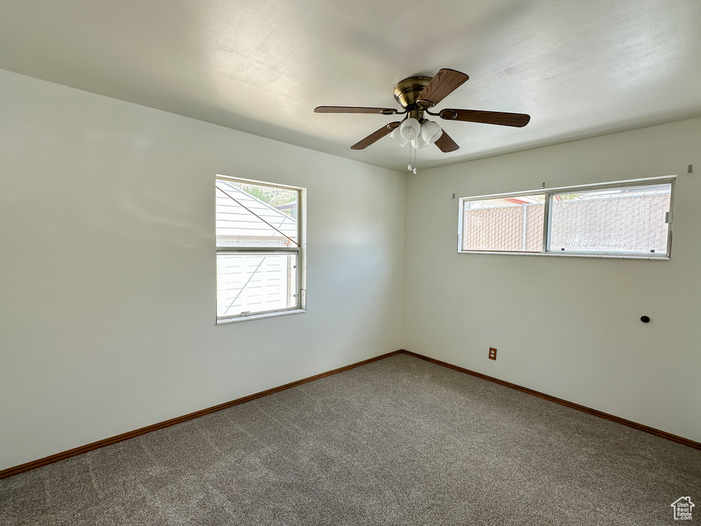 Spare room with ceiling fan and carpet