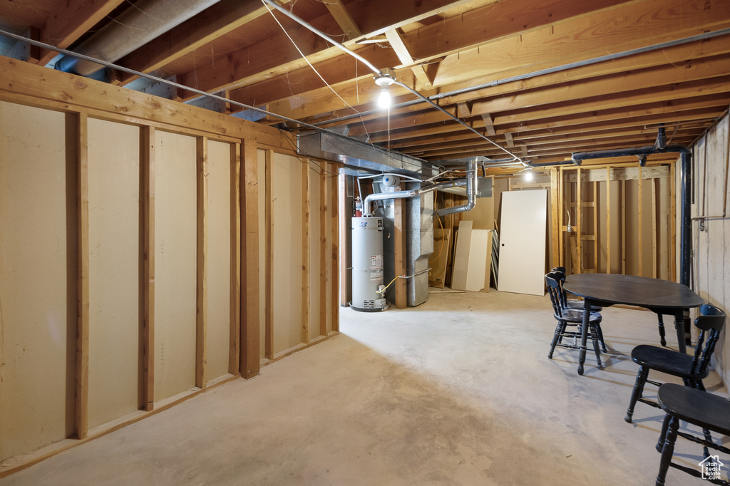 Basement with strapped water heater and heating utilities