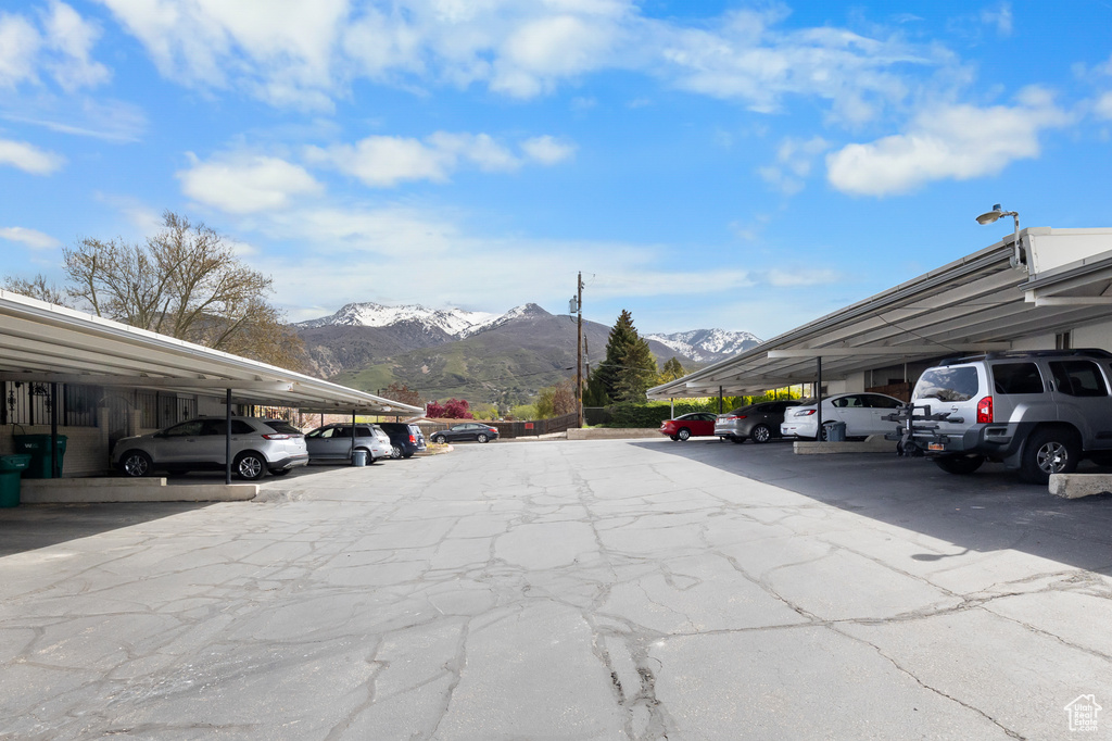 View of car parking with a carport and a mountain view
