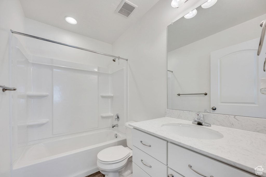 Full bathroom with large vanity, bathing tub / shower combination, and toilet