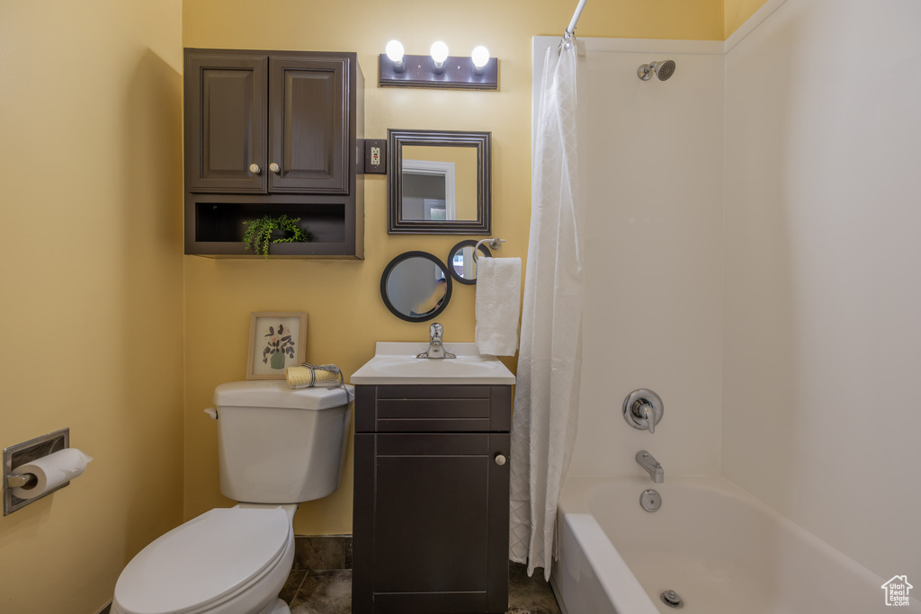 Full bathroom featuring tile floors, shower / tub combo, vanity, and toilet