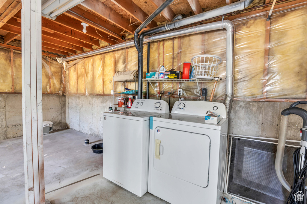 Laundry area featuring electric dryer hookup and washer and clothes dryer