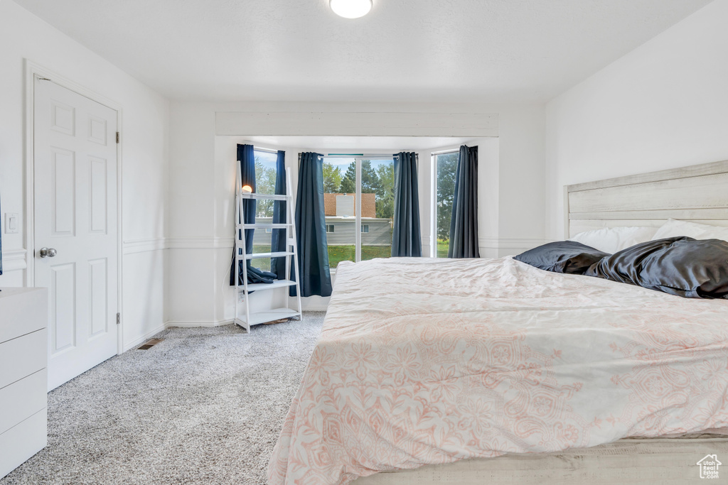 Unfurnished bedroom featuring light carpet
