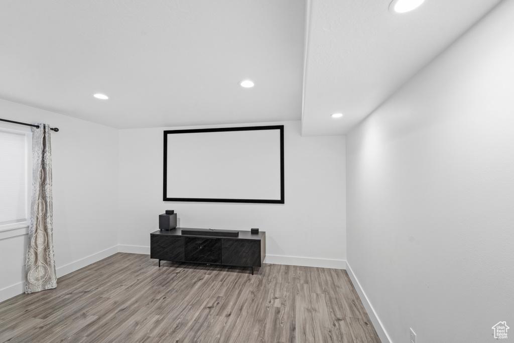 Home theater with hardwood / wood-style flooring