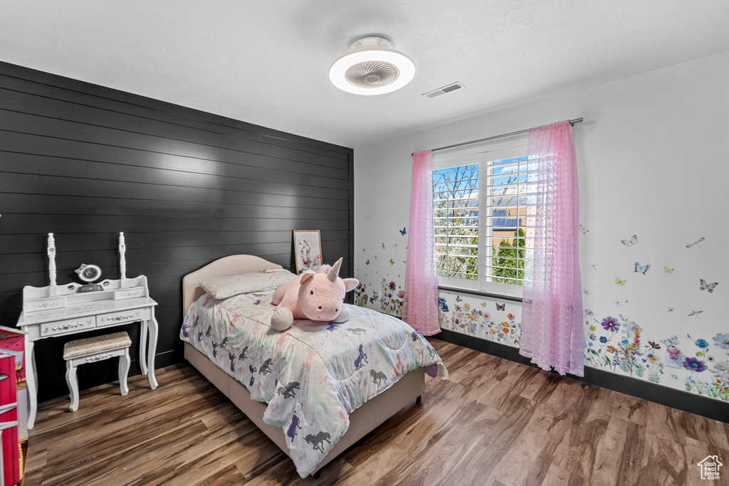 Bedroom with hardwood / wood-style flooring