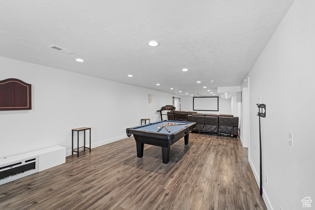 Recreation room with wood-type flooring, pool table, and a textured ceiling