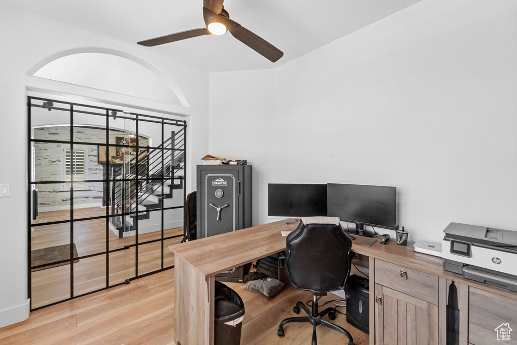 Office space with ceiling fan and light hardwood / wood-style floors