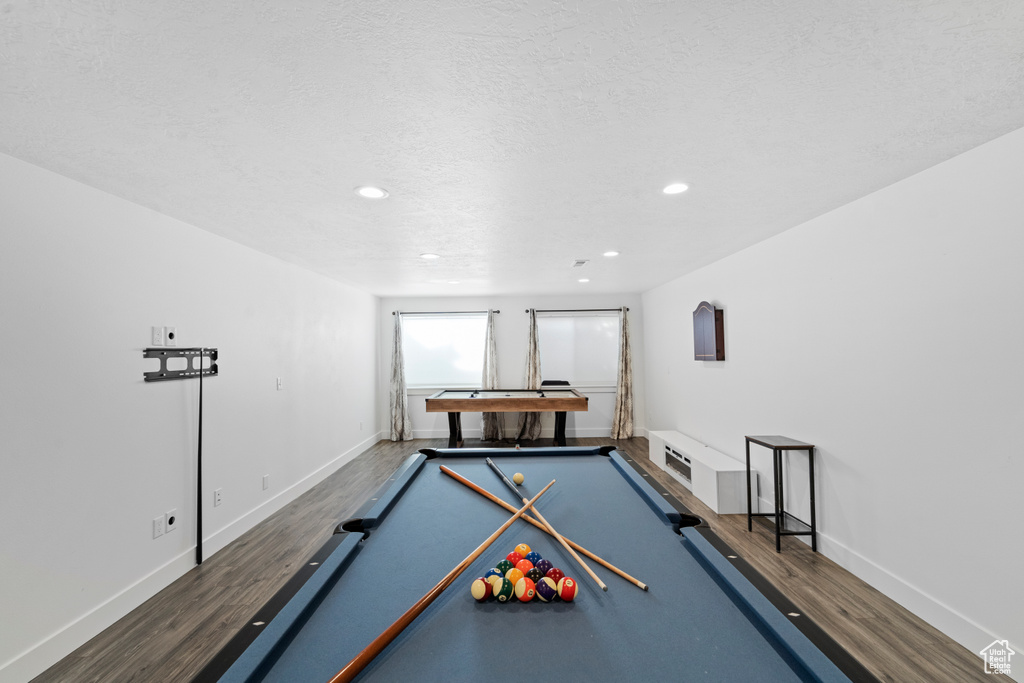 Rec room featuring wood-type flooring, billiards, and a textured ceiling