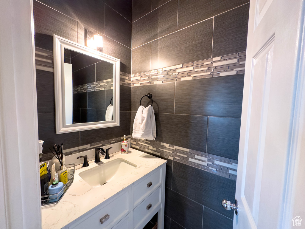 Bathroom with oversized vanity and tile walls