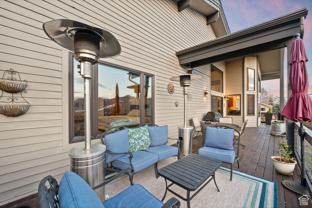 Patio terrace at dusk featuring an outdoor living space