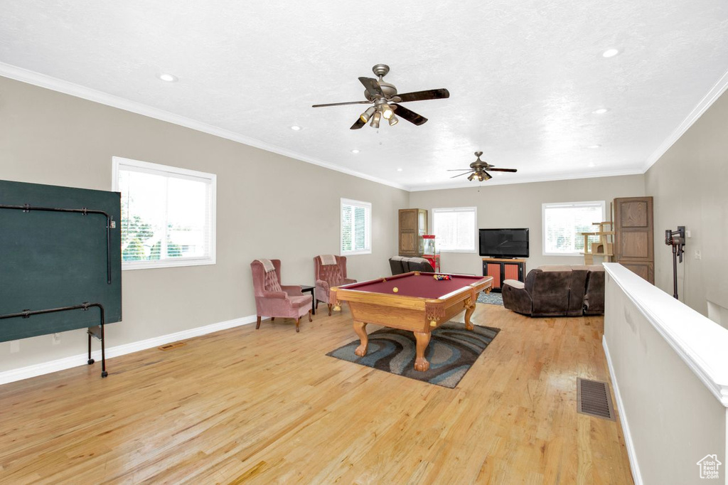 Playroom with light hardwood / wood-style flooring, billiards, ceiling fan, and crown molding