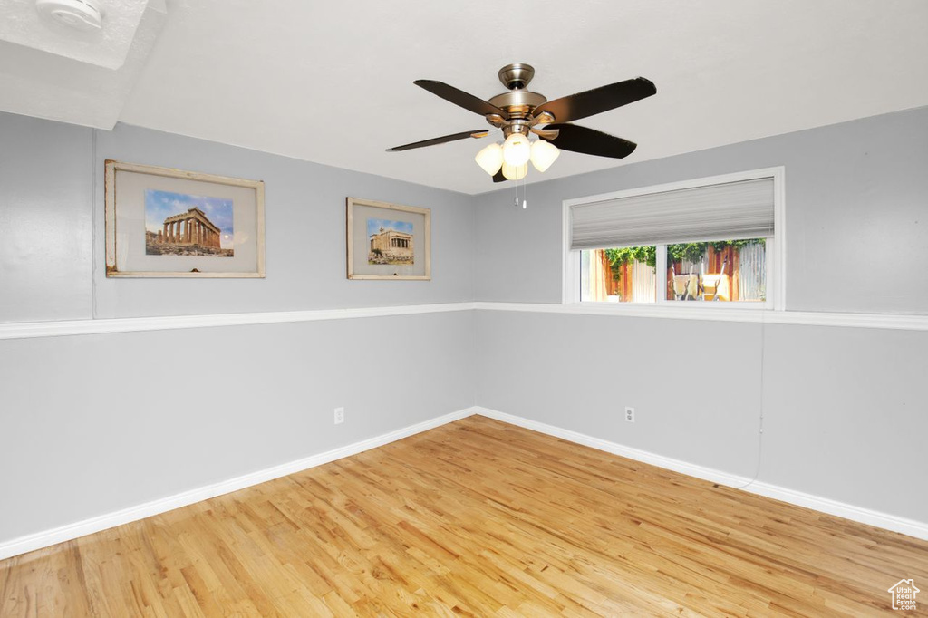 Unfurnished room featuring ceiling fan and light wood-type flooring
