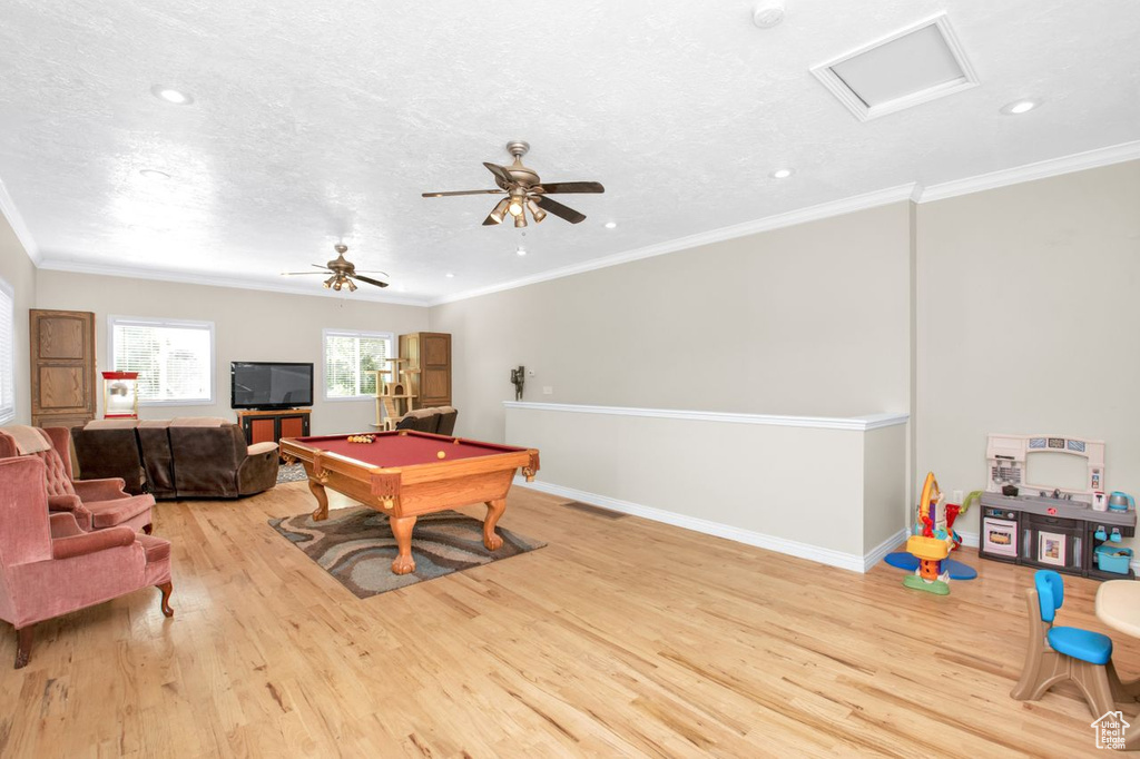 Rec room with ornamental molding, light hardwood / wood-style floors, ceiling fan, and pool table