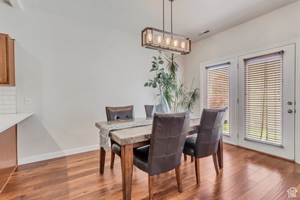 Dining space with hardwood / wood-style floors
