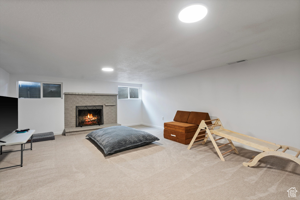 Interior space with carpet flooring and a fireplace