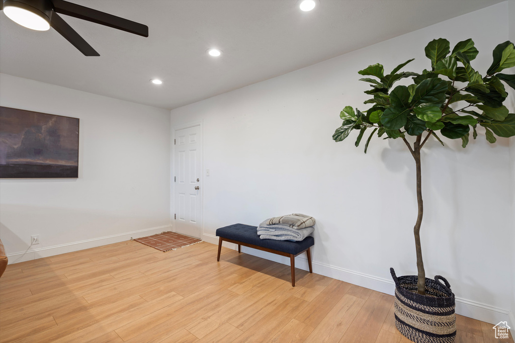 Sitting room with ceiling fan and light wood-type flooring